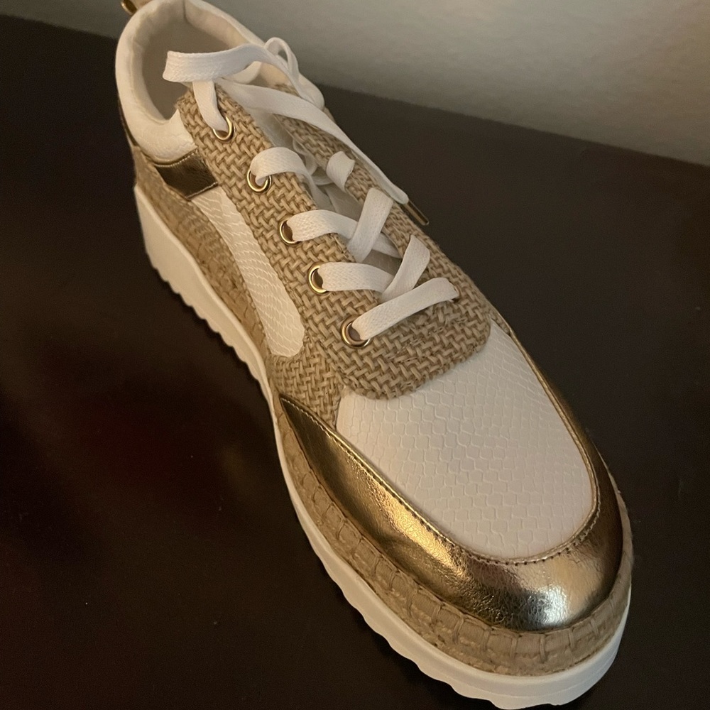 White and gold platform lace up shoe.